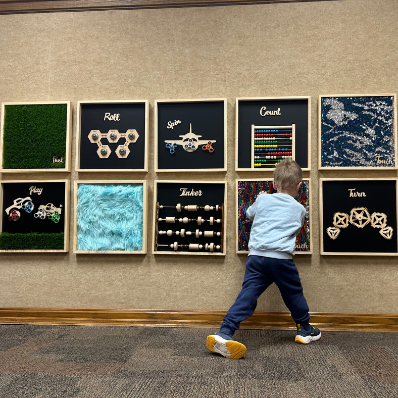 boy playing with sensory boards